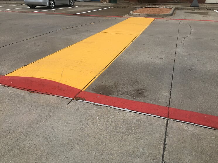 Yellow speed bump in parking lot Lenexa Kansas